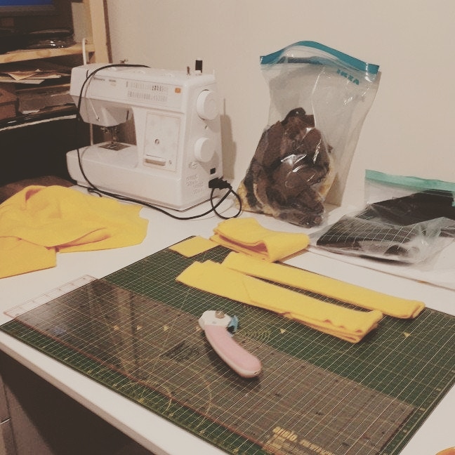 crafting desk with sewing machine and yellow fabric